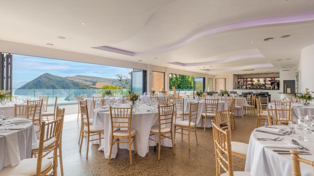 Inside The Venue at Sandy Cove Hotel with tables set up for a wedding reception