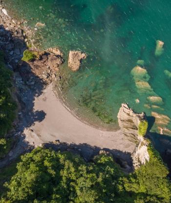 An aerial view over Broadsands Beach near Sandy Cove Hotel