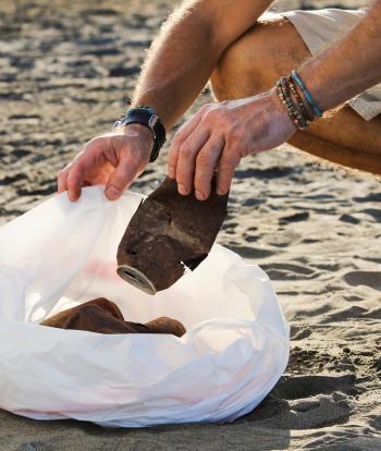 Man litter picking on a beach