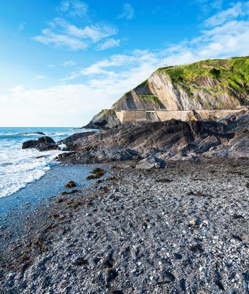 Beautiful rocky bay at Wildersmouth, Ilfracombe beach, surrounded by the cliffs, view of the sea and stones.