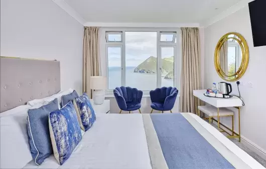 The interior of a classic room at Sandy Cove Hotel showing the view over the bay from the window