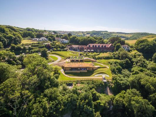 An exterior view of Sandy Cove Hotel and The Venue surrounded by North Devon countryside