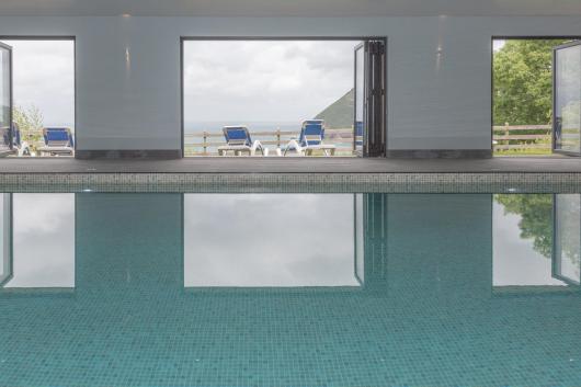 A view outdoors over the bay from the swimming pool at Sandy Cove Hotel