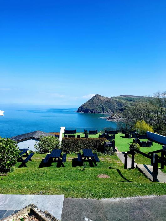 A view of the sea and countryside from Sandy Cove Hotel's outdoor terrace