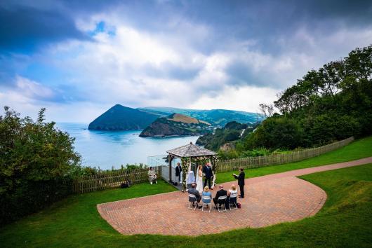 An intimate wedding under the Gazebo at The Venue, Sandy Cove Hotel, with a view of the bay in the background